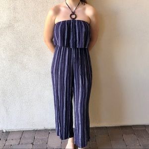 Navy blue jumpsuit with white stripes.